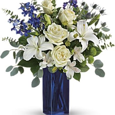 With its deep cobalt glass vase and pure white blooms, this soothing bouquet is a stylish gesture for any special occasion!
This arrangement includes white roses, white asiatic lilies, white alstroemeria, green button spray chrysanthemums, blue eryngium, bupleurum, spiral eucalyptus, silver dollar eucalyptus, and lemon leaf.