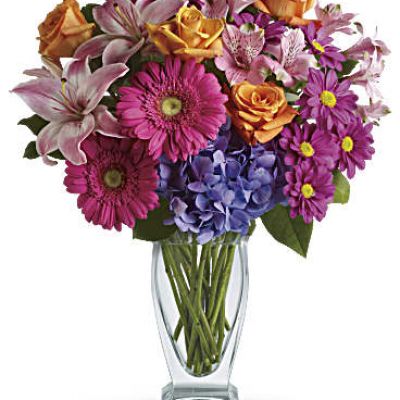 Featuring a wide, wondrous assortment of blooms in one bouquet, this colorful arrangement is always a favorite! Hydrangea, roses, lilies, alstroemeria, gerberas, daisies - they're all here in stunning variety.
This versatile mix includes blue hydrangea, orange roses, light pink asiatic lilies, pink alstroemeria, hot pink gerberas and purple daisies with a bit of rich green salal.