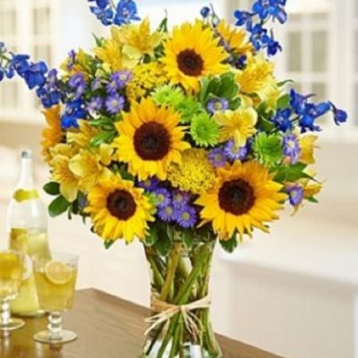 Send some sunshine with this bouquet full of fresh sunflowers, delphinium, alstroemeria, yarrow, monte casino and more!