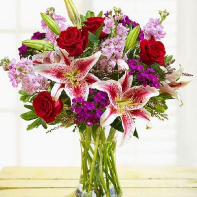 Enjoy this exquisite combination of red and purple bloom guaranteed to make your recipient equally dazzled with the unparalleled beauty of this arrangement. Whether it's for a special occasion or just because, it's a gift that you'll be glad you sent.